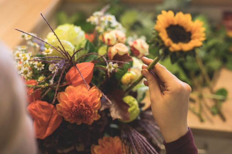 Detailaufnahme einer Blume, die in einen Strauß gesteckt wird
